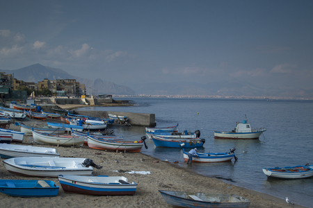 early morning shot of fishing boats and fishermen on the beach in the town of Aspra, sicilyのeditorial素材