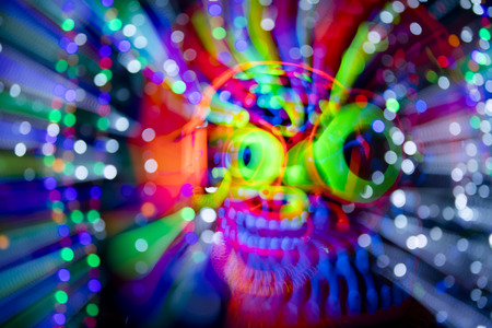 freaky monster UV fluorescent scary mask with headphonesの写真素材
