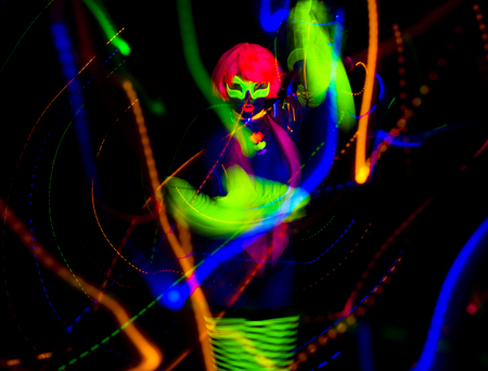 sexy female disco dancer posing in UV fluorescent costumeの写真素材