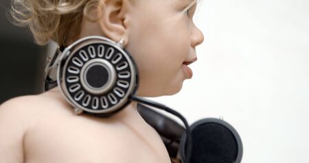 Head shot of cool baby girl in vintage headphone