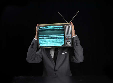 Man wearing suit with TV on headの写真素材