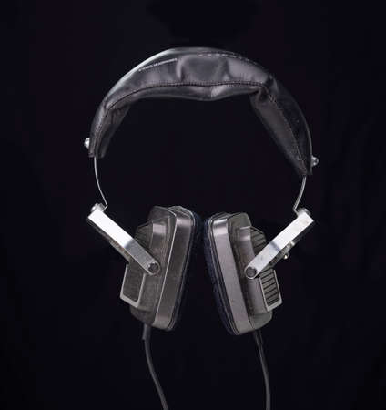 vintage headphones against black backgroundの写真素材