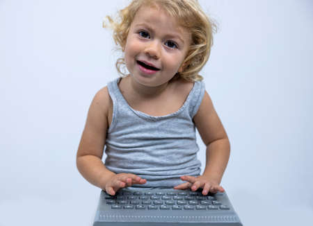 Small girl typing on keyboardの写真素材