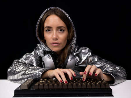 Woman with silver costume typing on keyboard