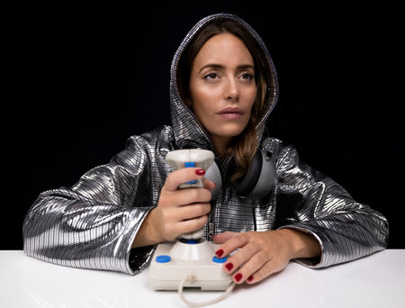 Woman with silver costume and computer joystick