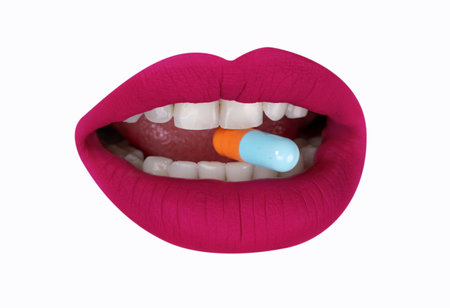 Cutout of womans lips with pillsの写真素材