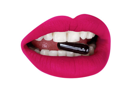Cutout of womans lips with pillsの写真素材