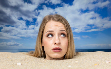 Woman buried in sand on beach