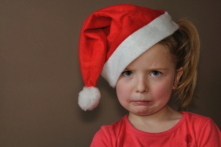 Sad girl in santa capの写真素材