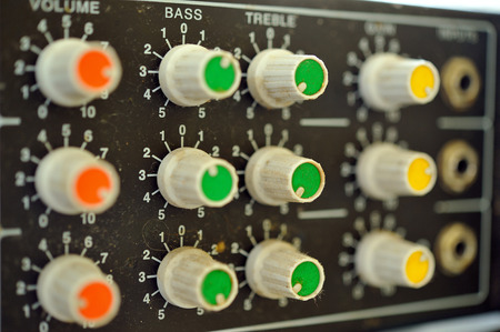 Dirty amplifier control panel with volume, bass, treble and gain tuning controls