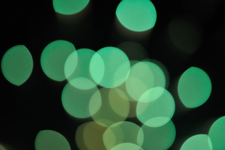 Fireworks flash show on dark night sky as green circlesの写真素材