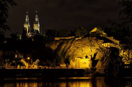 Vysehrad with Basilica of St Peter and St Paul in Prague from Vltava river side, Vysehrad, Czech Republic. Famous tourist destination beatifully lighted in the night.の写真素材