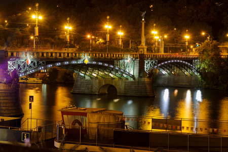 Svatopluk Cech Bridge in Prague. Beautiful night cityscape with river and bright lights of famous tourist destinationの写真素材