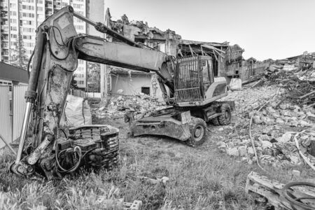 Excavator before demolish old building. City reconstruction. Black and whiteの写真素材