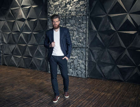 Handsome successful businessman with beard in elegant suit.