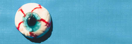 Eye with blue pupil on a blue background with space for textのeditorial素材