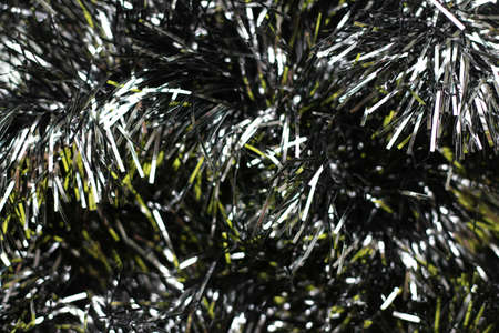 Silvery texture of New Years glitter rain decoration for the sparkling background of Christmas and New Year 2022. Gray background with glitter close-upの写真素材