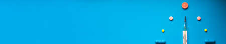 Medical banner for an advertising header on the website of medical services, clinics. Medical supplies on a blue background. Disease. Tablets and thermometer. Place for your text. Copy space. Layout.の写真素材