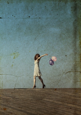 young girl walks and waves the balloonsの写真素材
