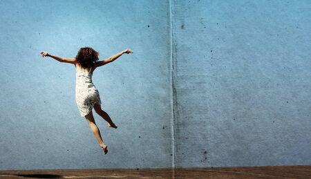 funny jump of young woman. freedom.の写真素材