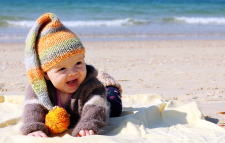 cute 4-month old baby on the beachの写真素材