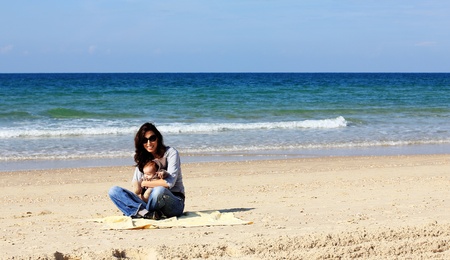 mother with her child on the beachの写真素材