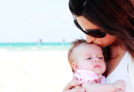 mother with her baby on the beachの写真素材