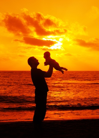 Dad with baby on sunsetの写真素材