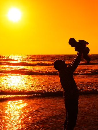 Dad with baby on sunsetの写真素材