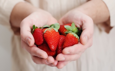 man holding a strawberryの写真素材