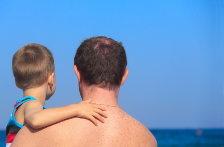 father and son playing together on the beachの写真素材