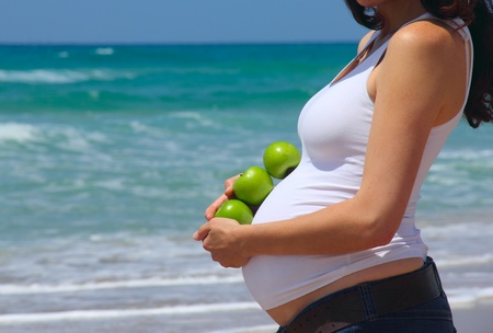 pregnant young woman at the seaの写真素材
