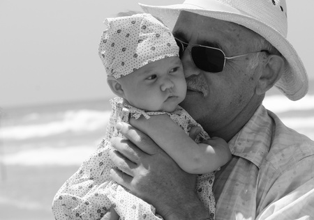 happy grandpa is holding a little granddaughter  Background - the sea の写真素材