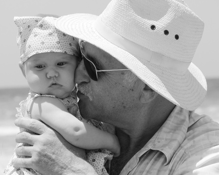 happy grandpa is holding a little granddaughter  Background - the sea の写真素材