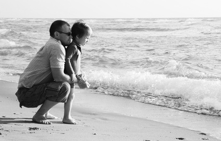 child with his father at seaの写真素材