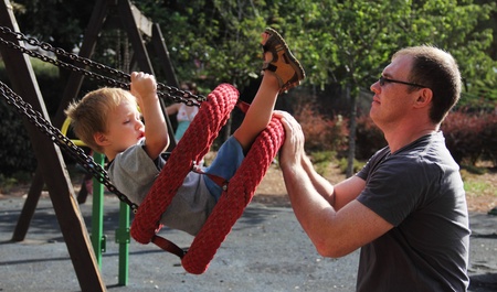 Father and son having fun on the playground の写真素材