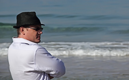 Handsome 30-year-old man in a hat at seaの写真素材
