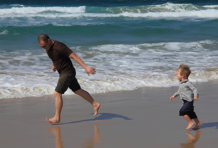 father at the beach with his sonの写真素材