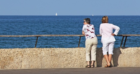 two seniors women bathing in the sea の写真素材