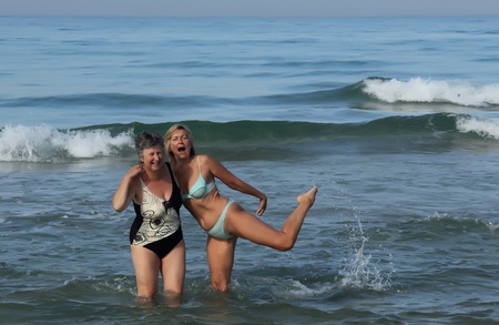 two seniors women bathing in the sea の写真素材