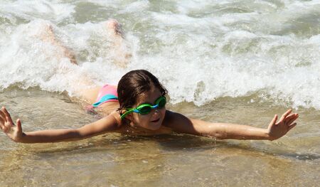 beautiful, funny, girl seven years at sea  There is no front teeth  She is wearing glasses for swimmingの写真素材