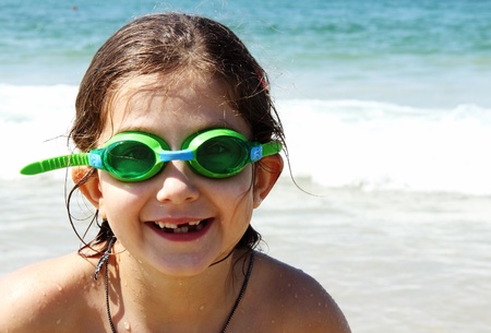 beautiful, funny, girl seven years at sea  There is no front teeth  She is wearing glasses for swimmingの写真素材