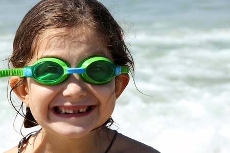 beautiful, funny, girl seven years at sea  There is no front teeth  She is wearing glasses for swimmingの写真素材