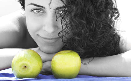 woman with two green applesの写真素材