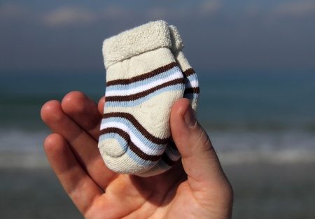 baby newborn socks in men's handsの写真素材