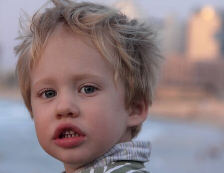 Portrait of a 3-year-old boy at sunsetの写真素材