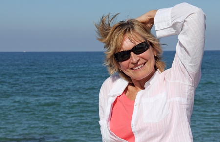 happy senior woman at the beach の写真素材