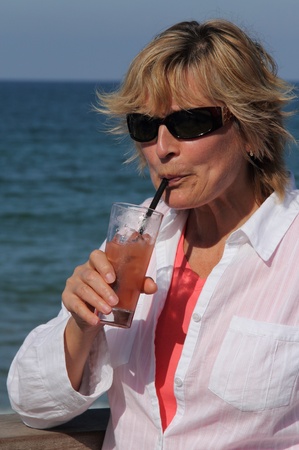 closeup of happy senior woman on beach の写真素材