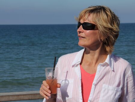 closeup of happy senior woman on beach の写真素材