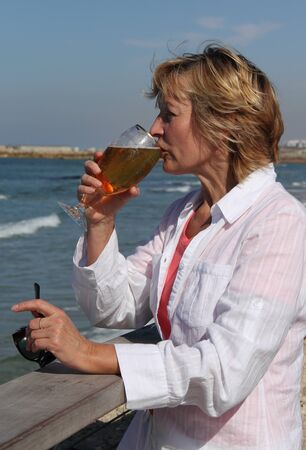 closeup of happy senior woman on beach の写真素材